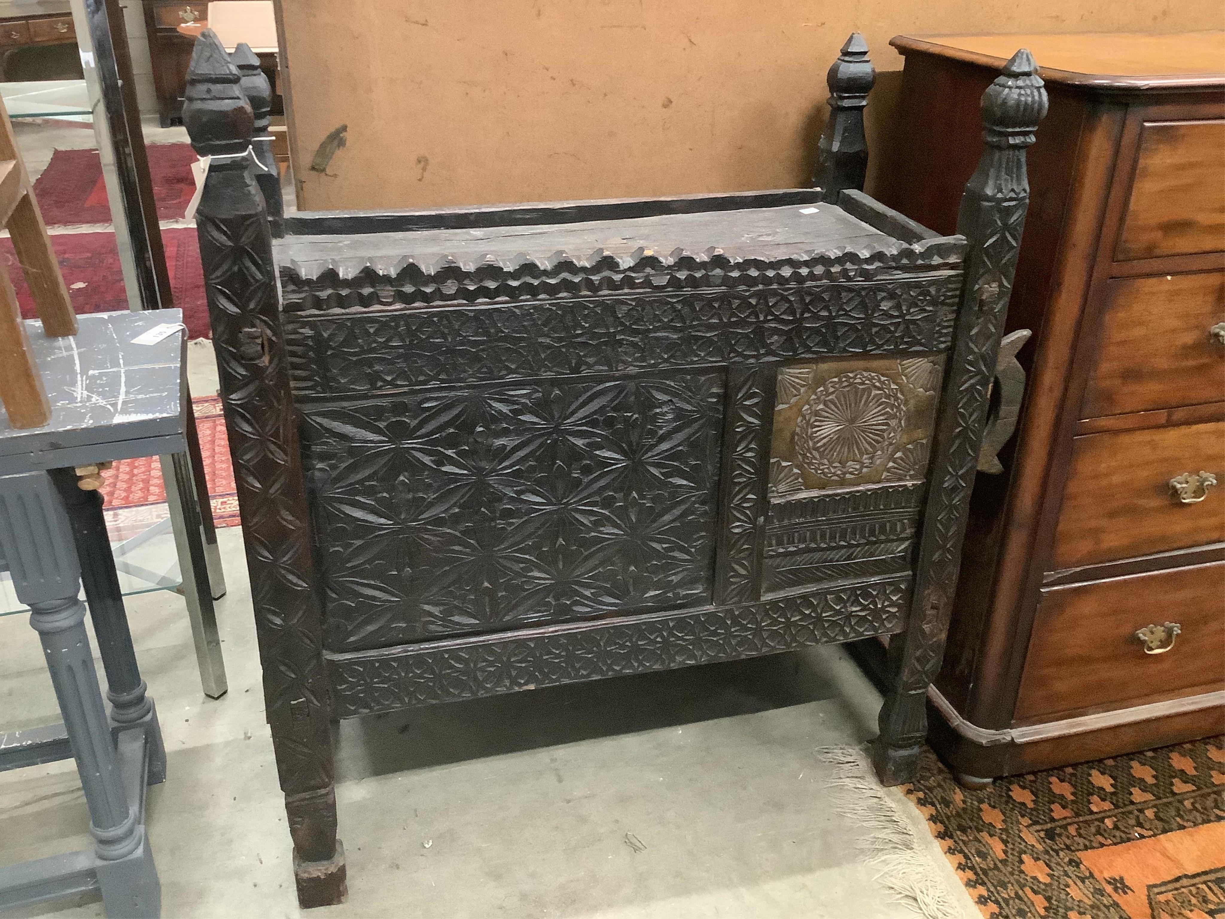 An Indian chip carved hardwood chest, width 99cm, depth 48cm, height 120cm. Condition - fair